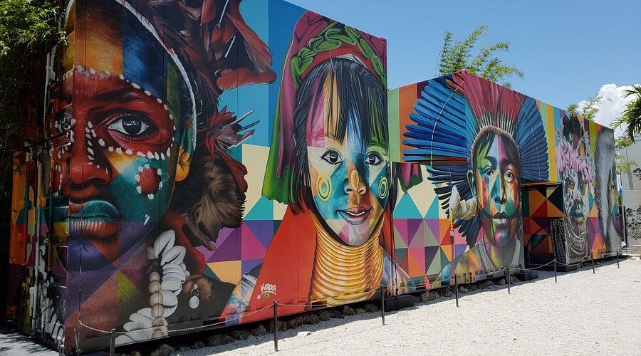 Shipping containers with large colorful murals of faces
