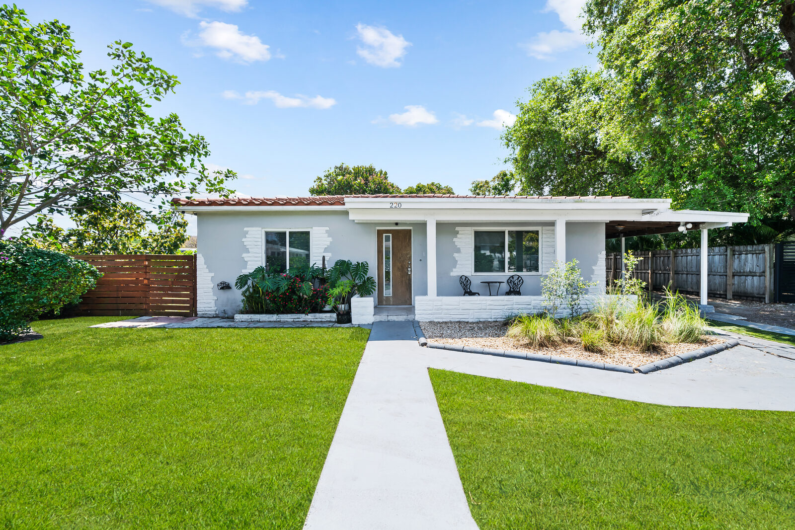 Front exterior of the 4BR Wynwood house with manicured lawn