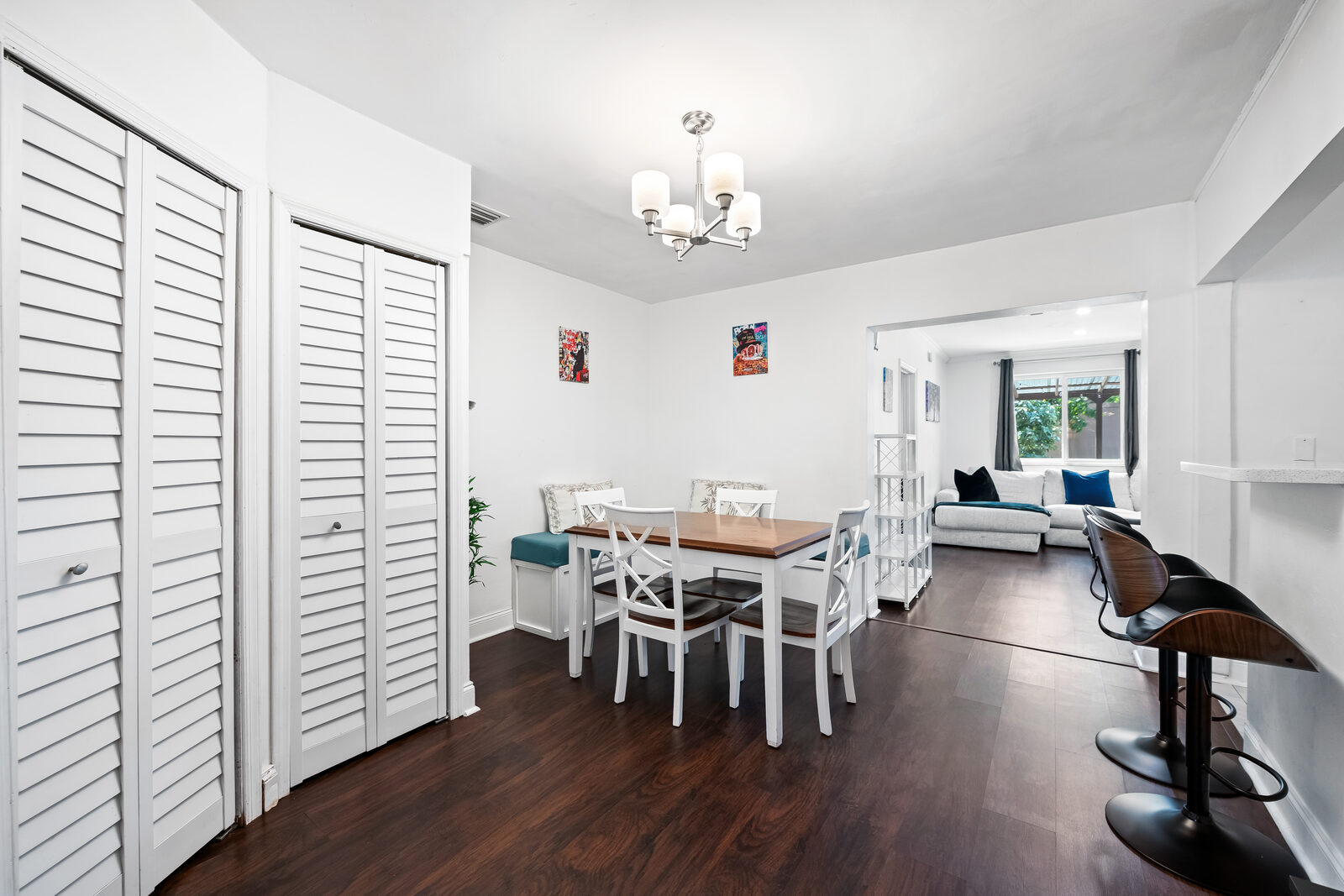 Interior dining area with white cross-back chairs and breakfast nook